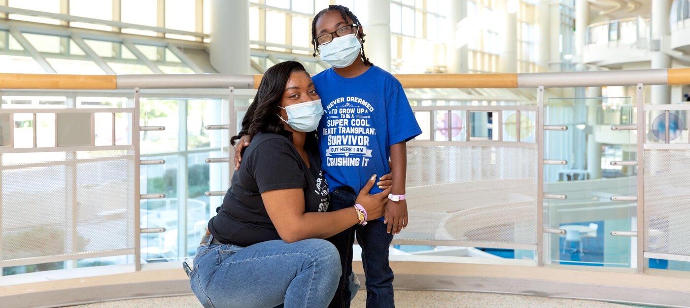 A mom and her son pose together in the hospital