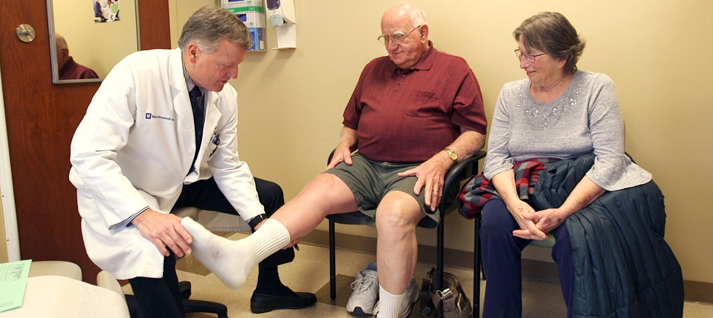 A provider looks at a patient's knee