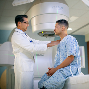 A provider helps a patient get ready for radiation