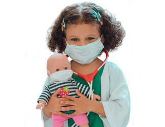 A child dressed up like a doctor holding a doll, both with masks on