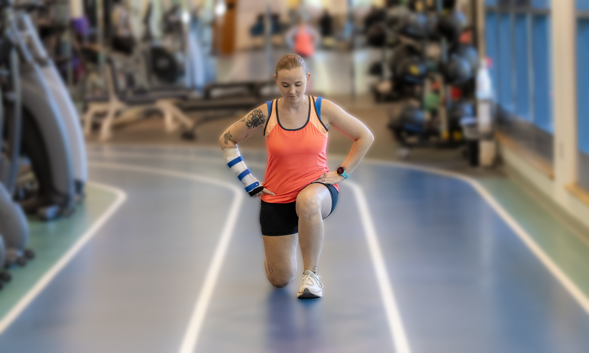 A athlete lunges down an indoor track
