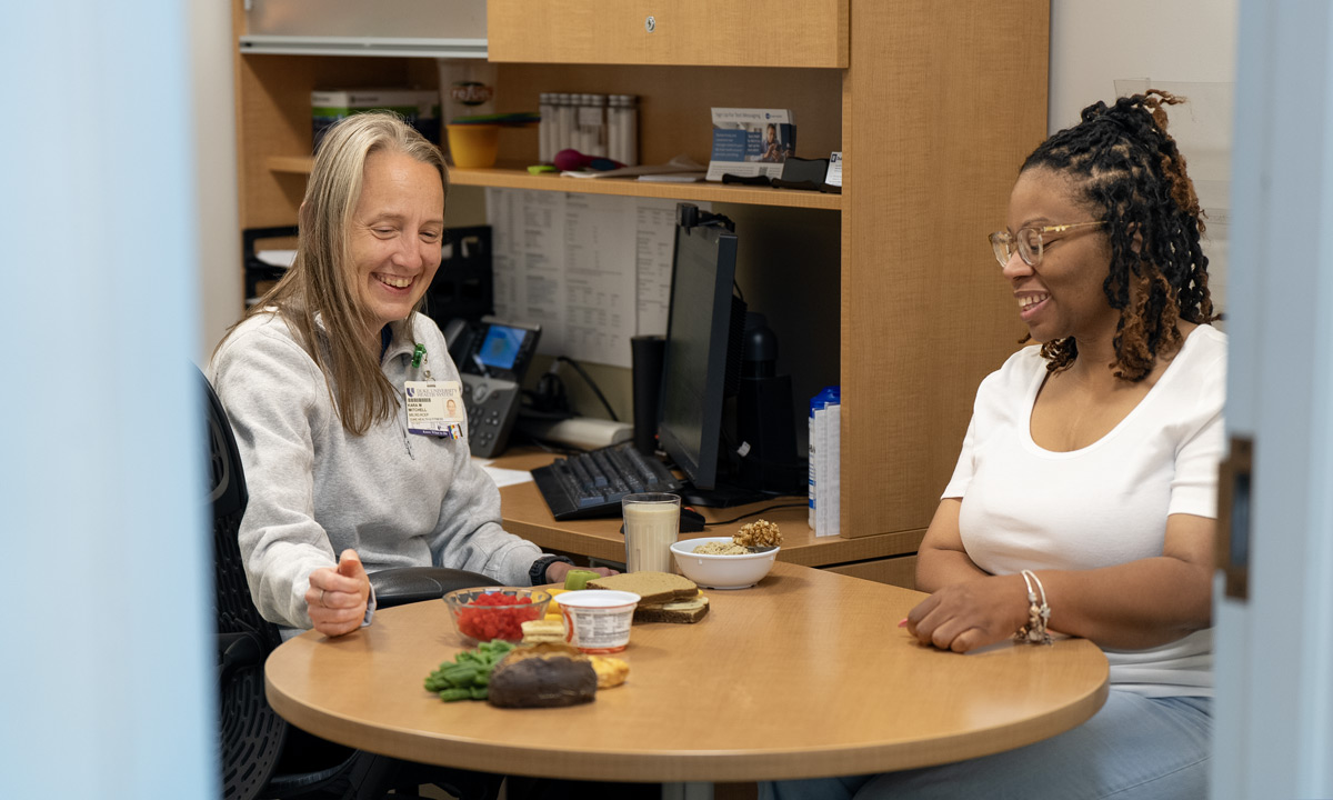 A provider shows a client portions of fake food during a nutrition session