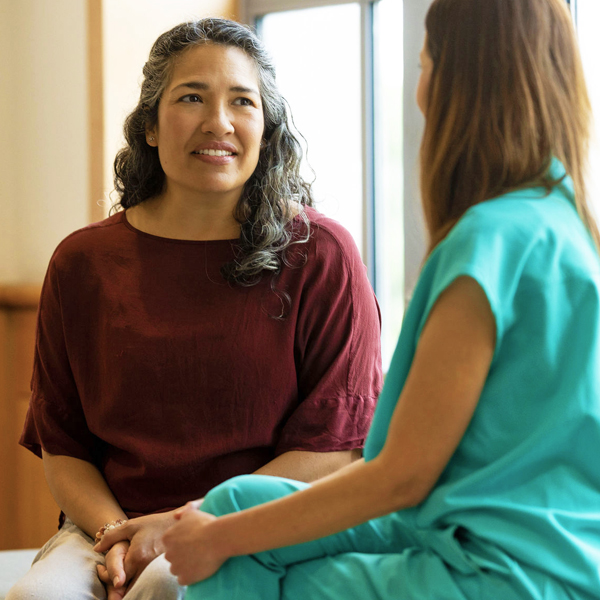 Woman meeting with clinician in office