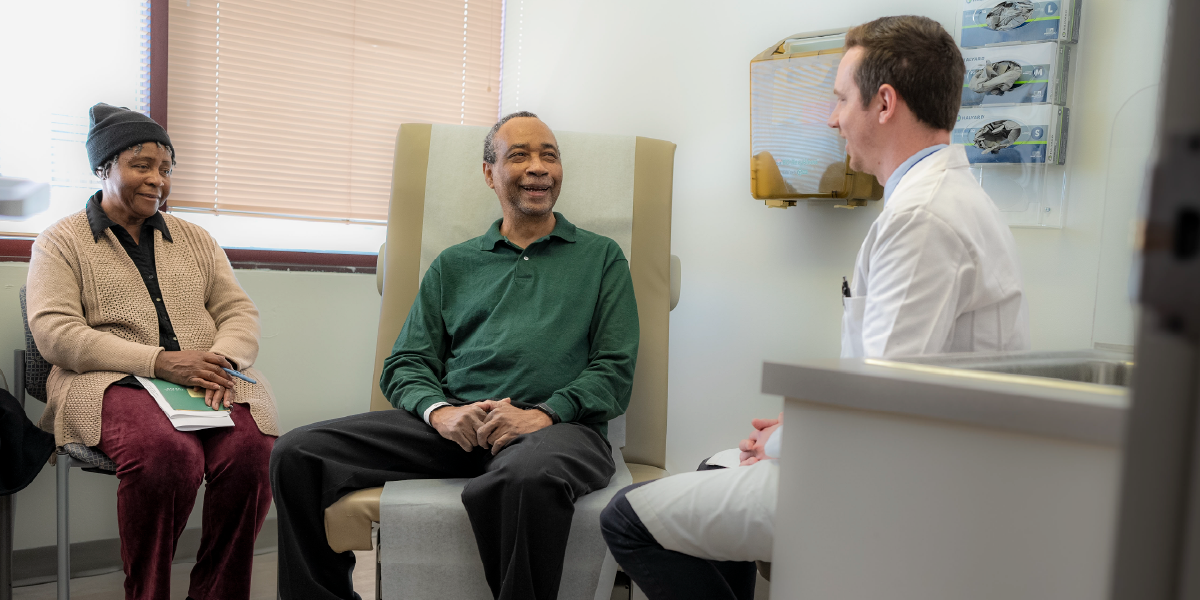 Dr. Cockrell consulting patient and family member in office