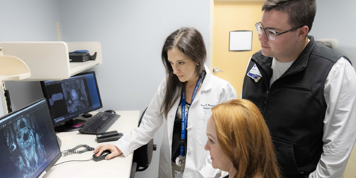 Dr. Morgan reviewing scans with 2 clinicians