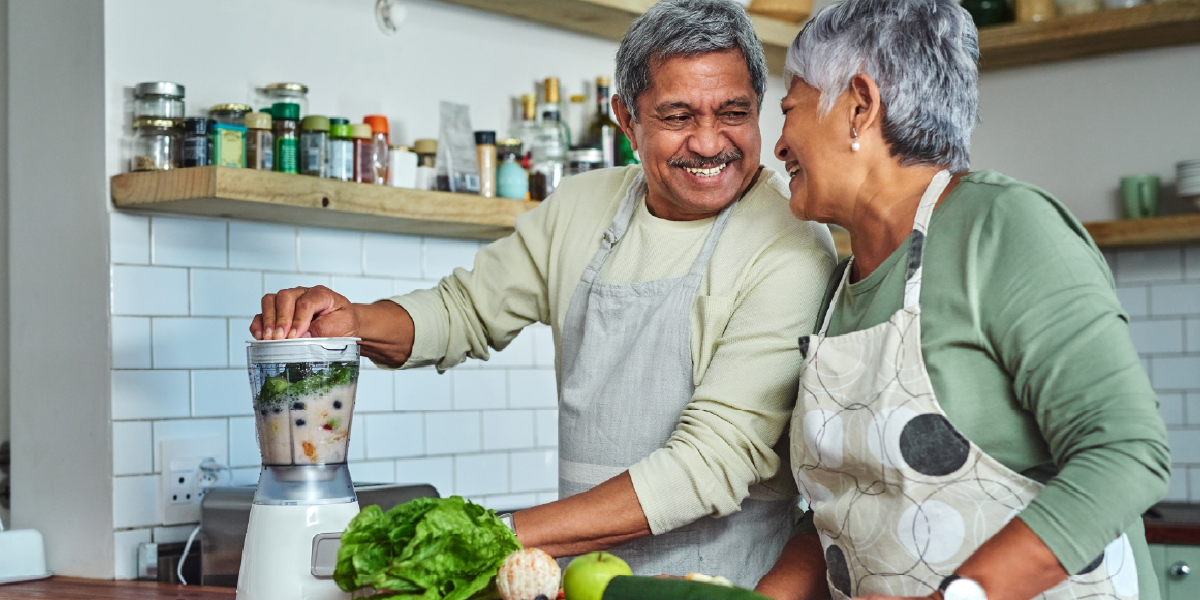 Happy couple cooking together in kitchen