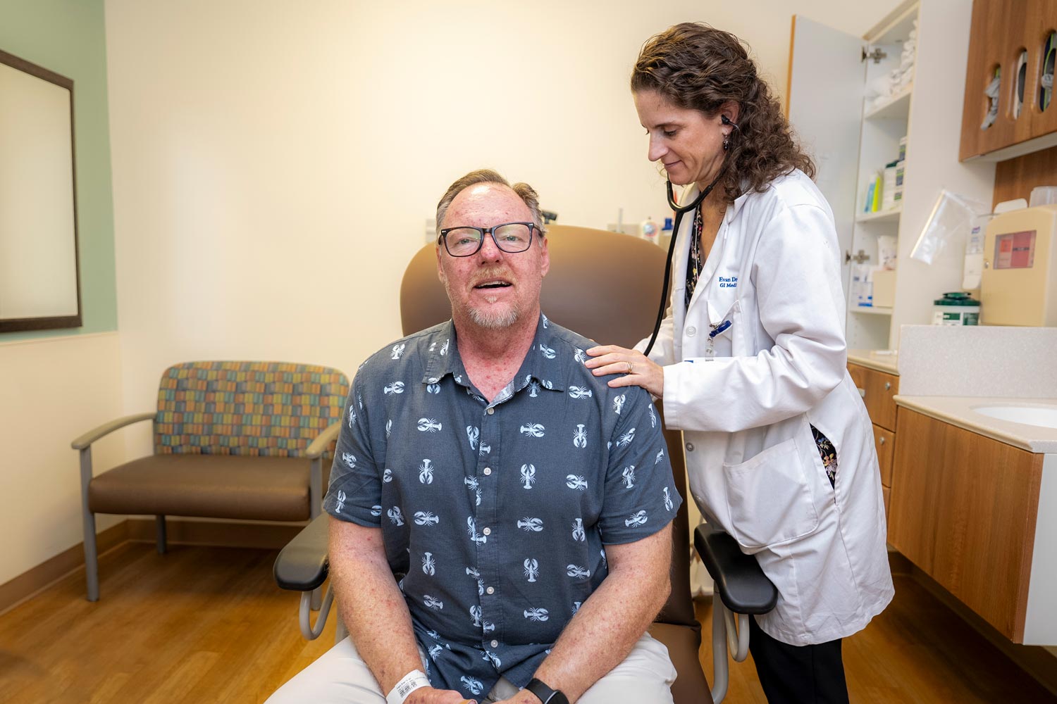 A doctor listens to Brad Dugai's heart and breathing.