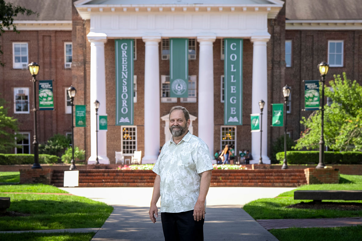 Bob Blake stands in front of the main building of Greensboro College.