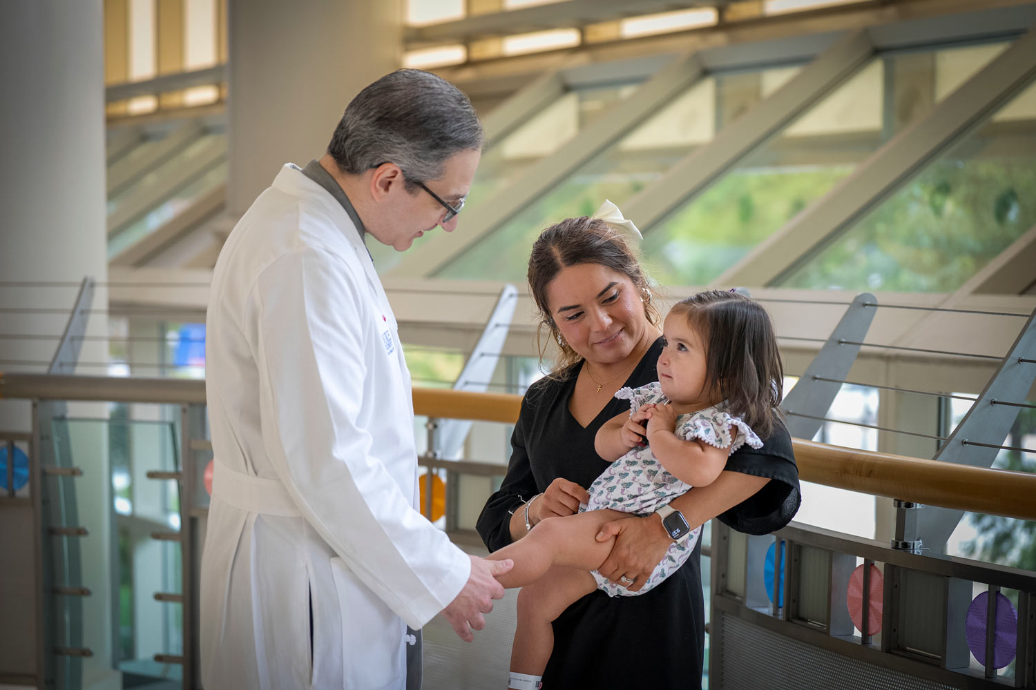 Alexander Allori, MD, says hello to Zoey and her mom. 
