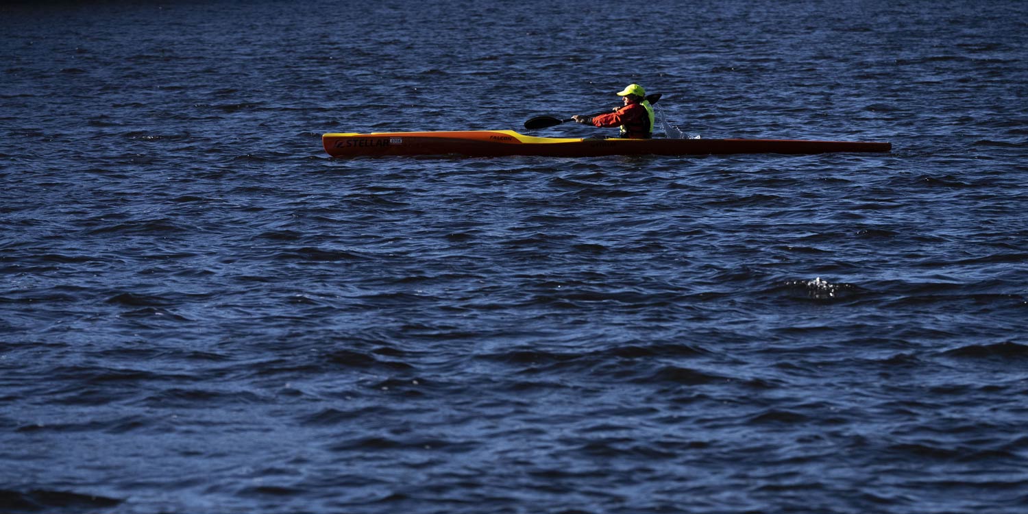 Vicki Reynolds is seen from afar in her kayak on a lake