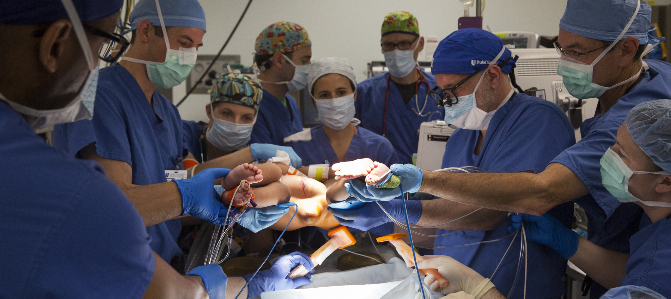 Duke surgeons and nurses lift and clean 8-month-old conjoined twins before surgery to separate them at Duke University Hospital in Durham on Thursday, June 18, 2015.