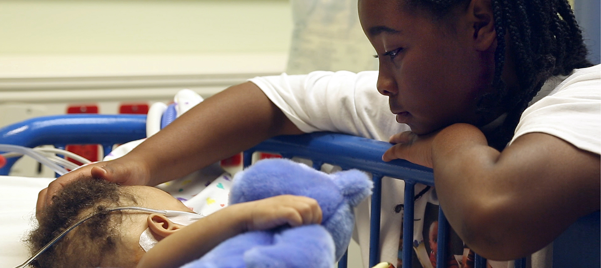 Jamiah Covington, the twins' sister, strokes Josiah's hair after his surgery.