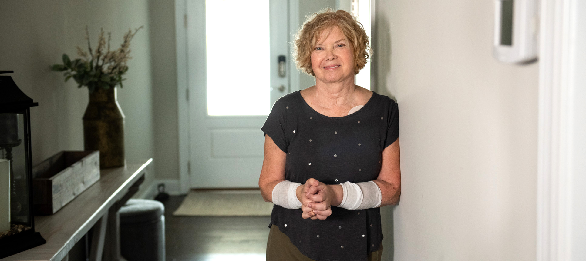 Deb Kelly stands in her house 