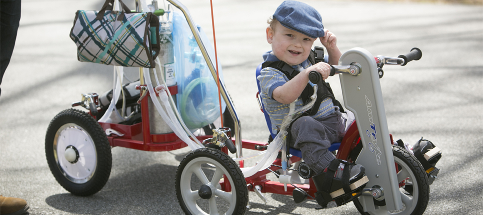 Collier Hart riding his tricycle