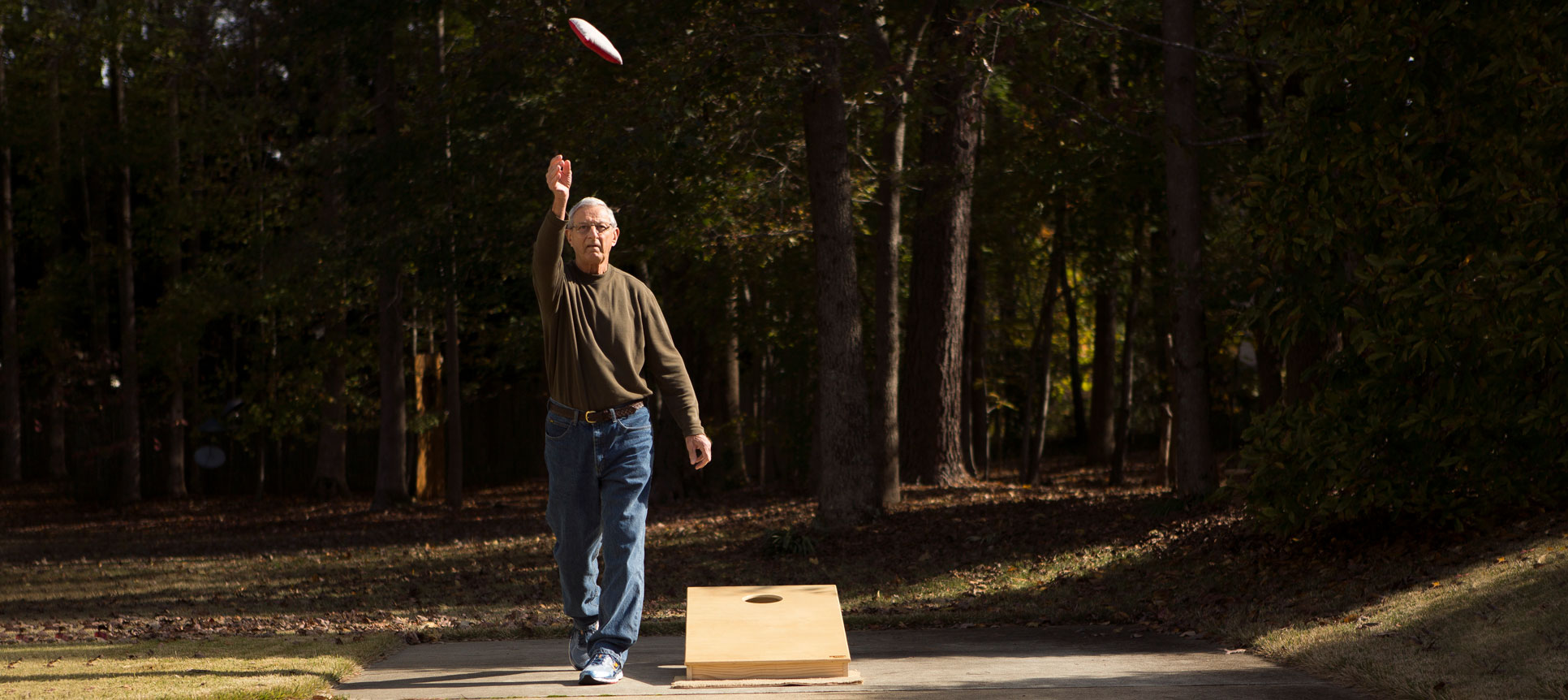 Dick Mazur tosses a cornhole bag.