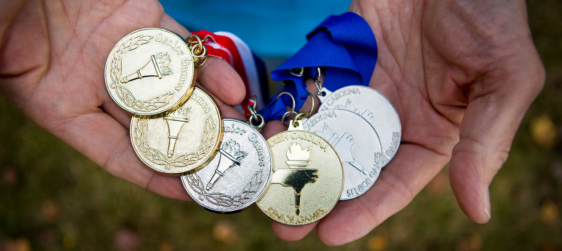Dick Mazur holds the medals he has won during the Senior Olympics.