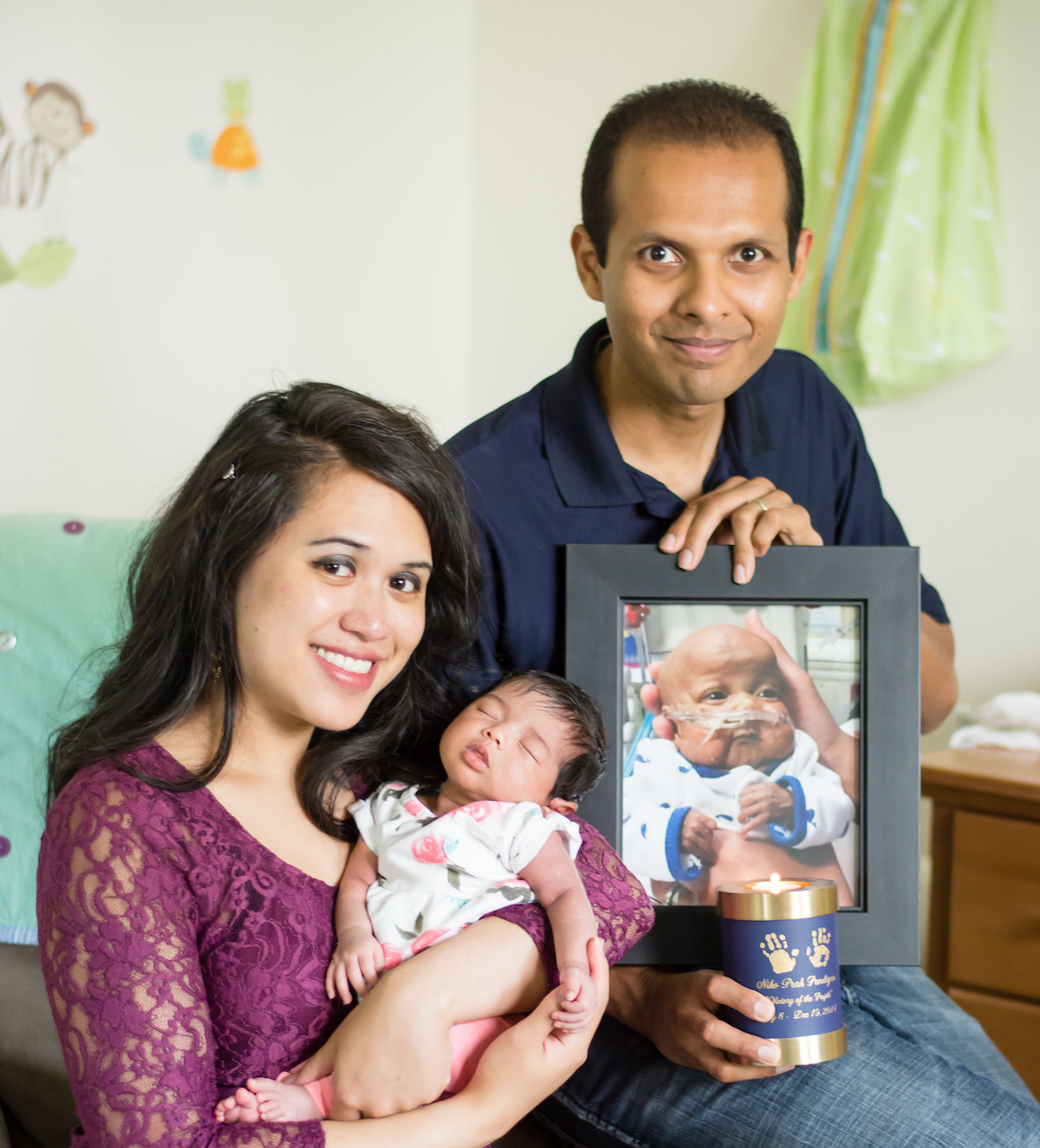 Family portrait with a photo of Niko (Linsley Schneider Photography)