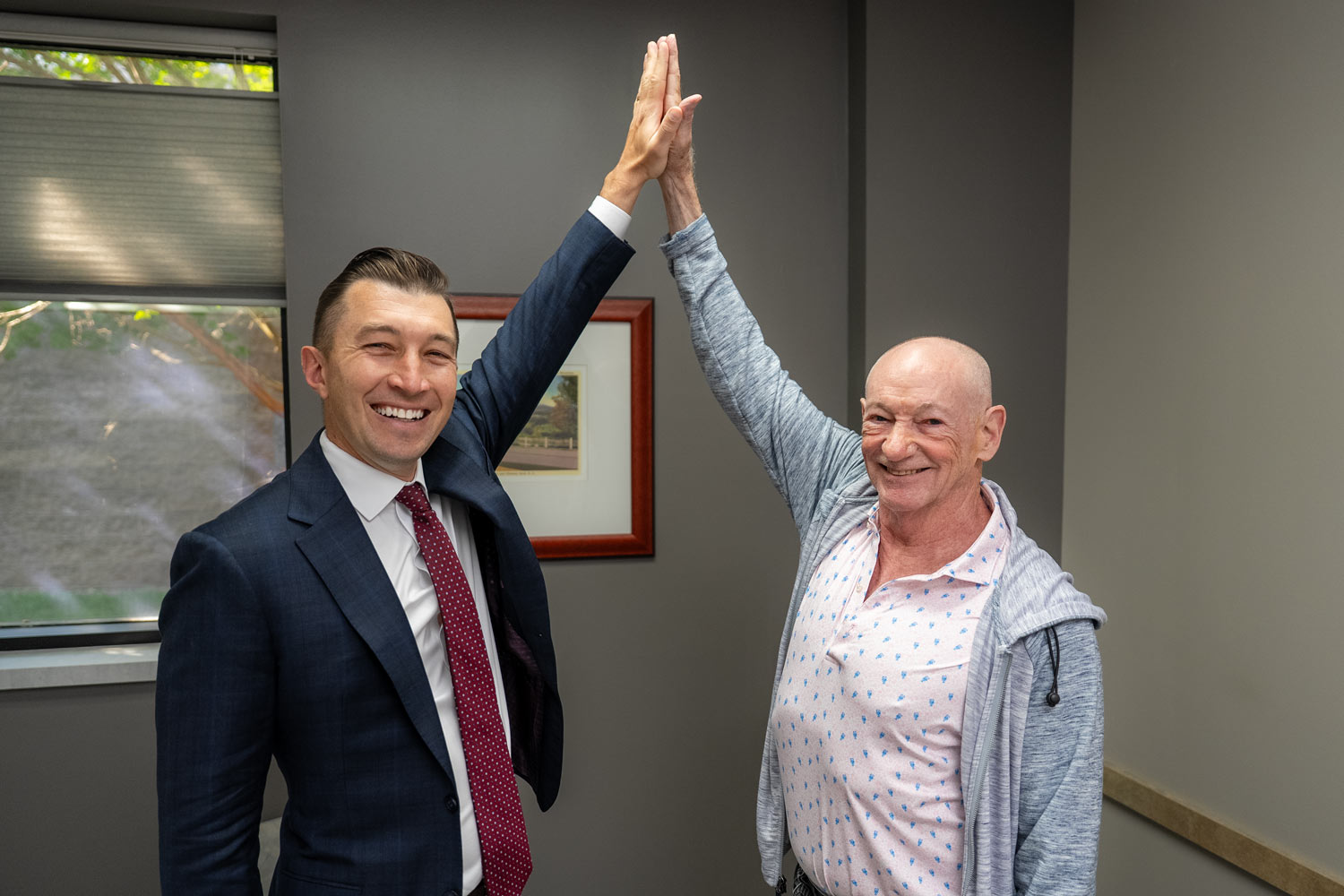 Christopher Klifto, MD and Daniel Sullivan high five at the end of a follow-up visit.