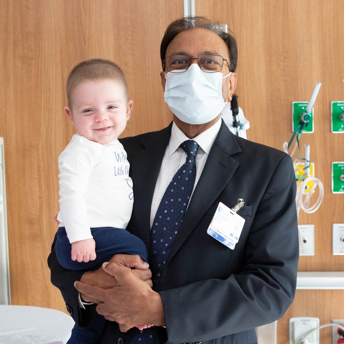 Dr. Prasad holds Everett as they both smile. 