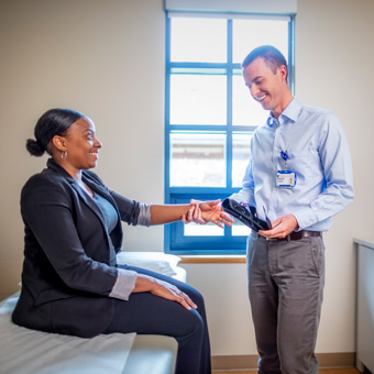 A provider prepares to put a wrist brace on a patient