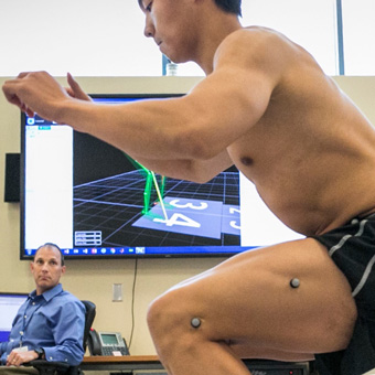 An athlete participates in testing at the K Lab as a provider looks on