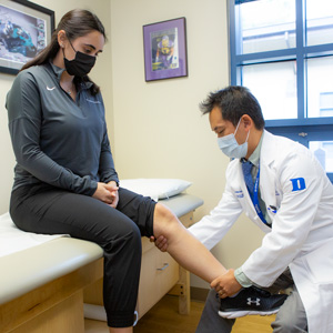 A provider examines a patient's knee