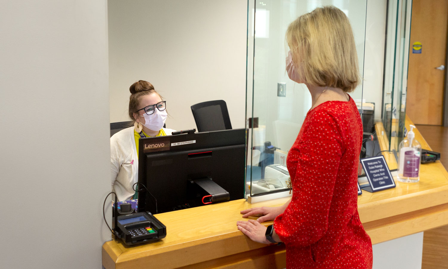 A patient checks in at the front desk