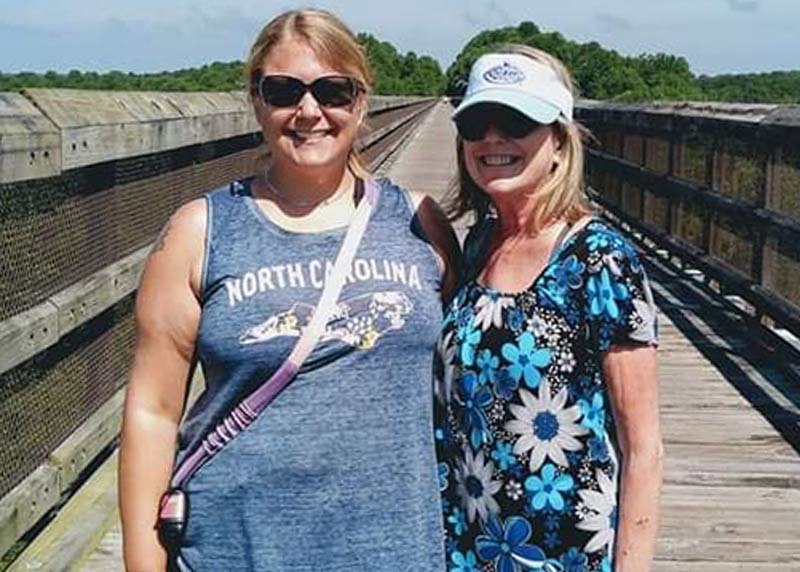 Carrie and her mother stand outside together