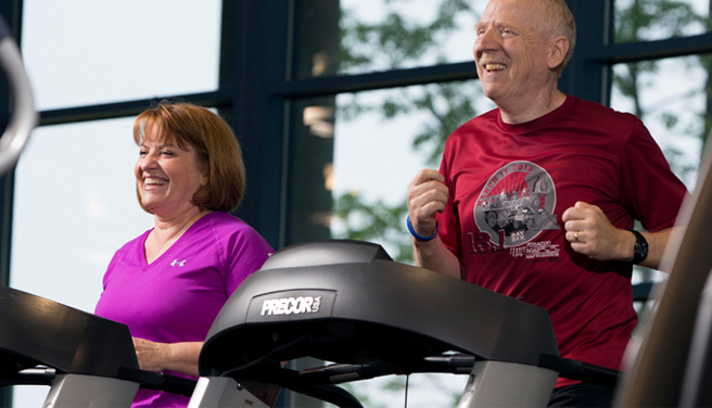 A couple exercises on treadmills at the Duke Health &amp; Fitness Center.