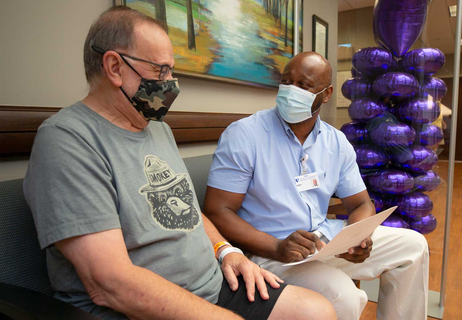 A financial counselor speaks with a patient 