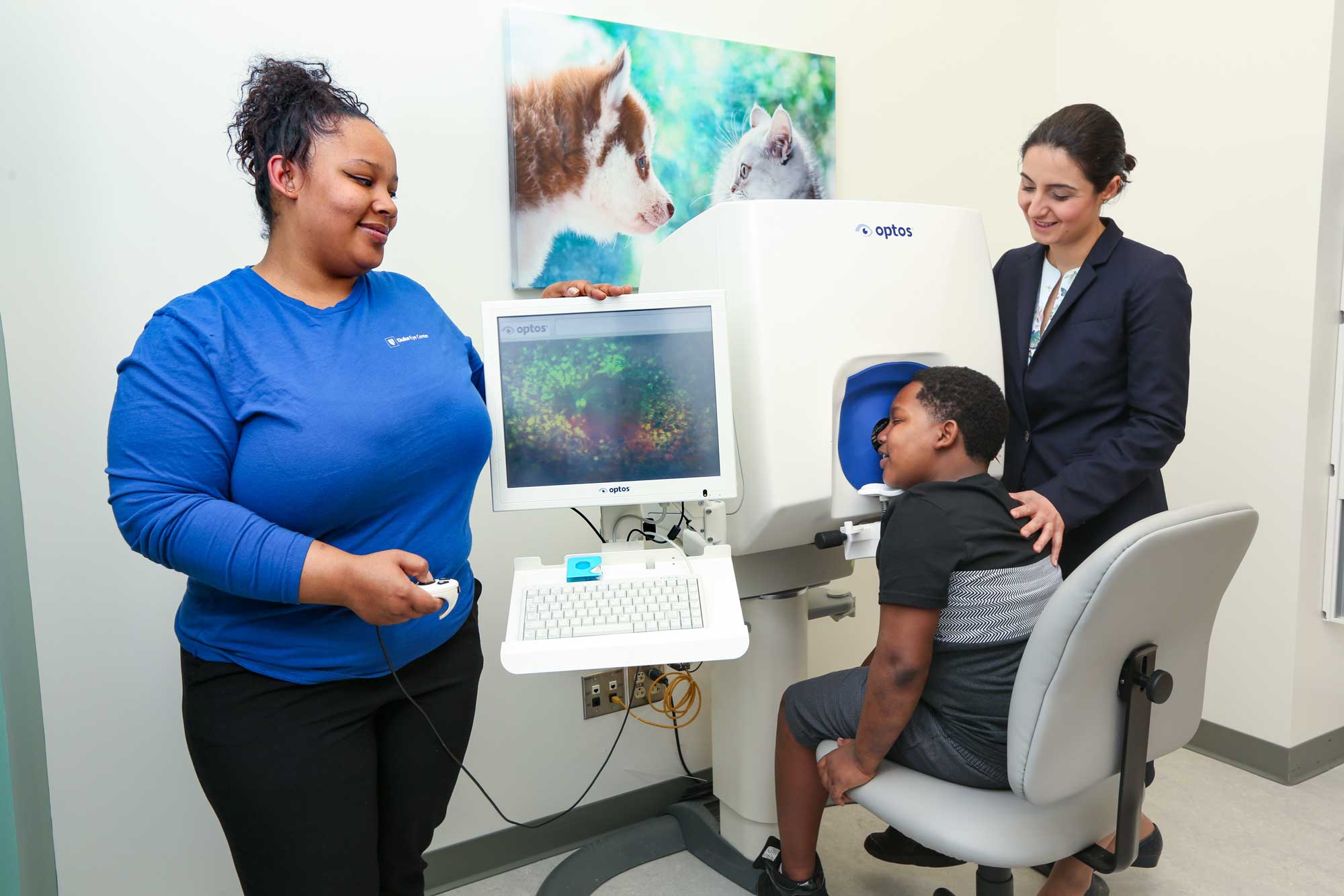 Two providers run an eye test with a young patient