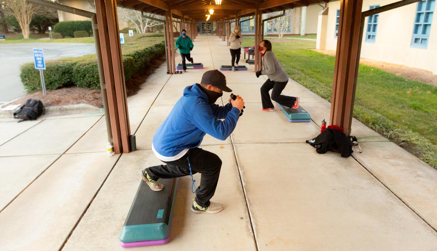 A group exercise class works out outside at the Duke Health &amp; Fitness Center
