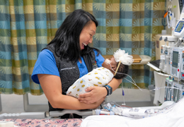 A nurse holds a baby