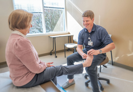 A doctor examines a patient's foot