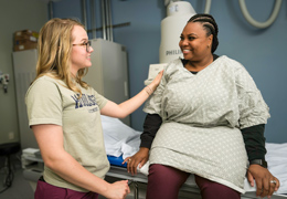 A provider helps a patient before a scan