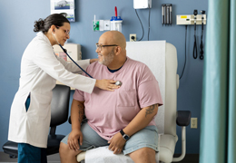 A doctor listens to a patient's heart