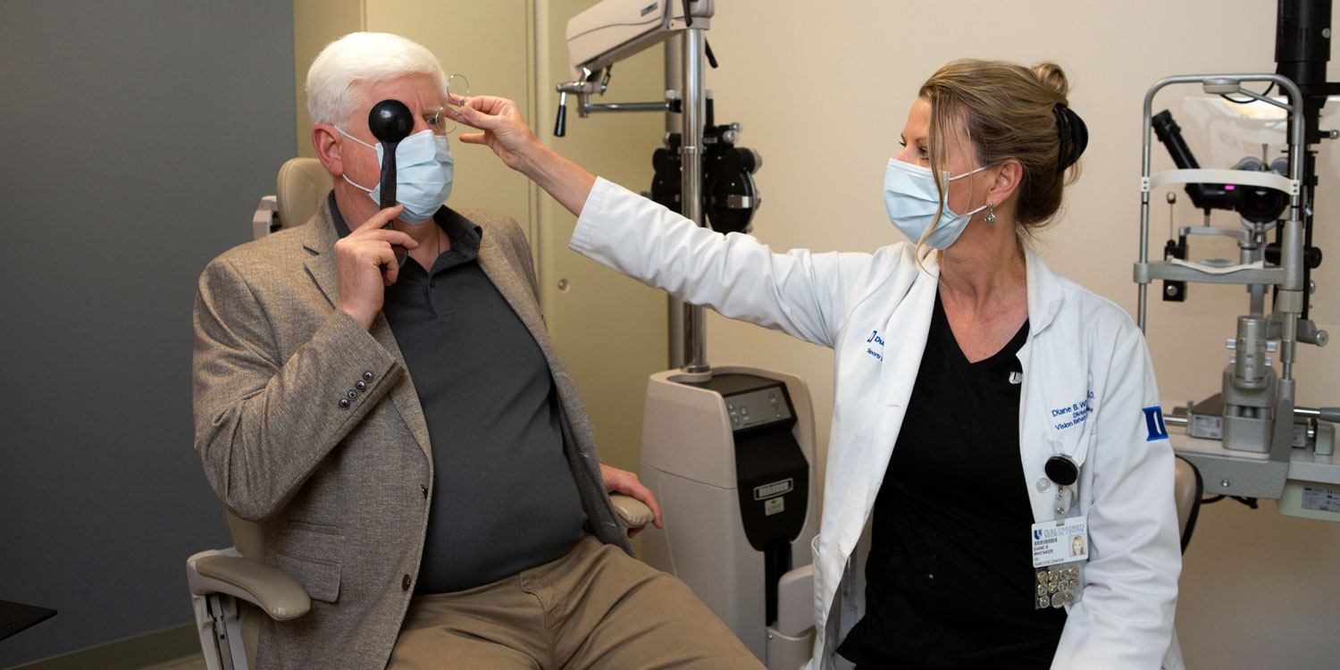 Diane Whitaker, OD works with Kevin Morgan during an eye exam.