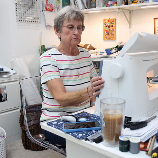 A woman uses a sewing machine