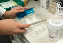 A pharmacist sorts pills