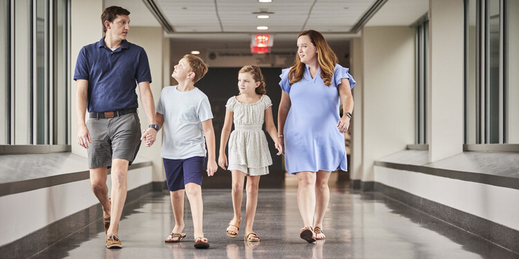 The McFadden Family walks down a hallway at Duke Cancer Center. 