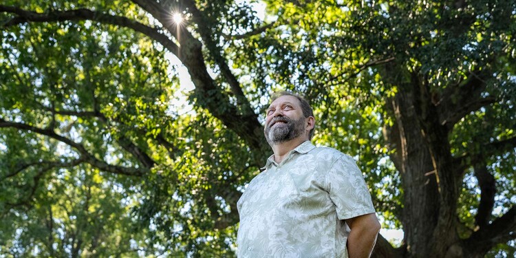 Bob Blake stands under a large tree