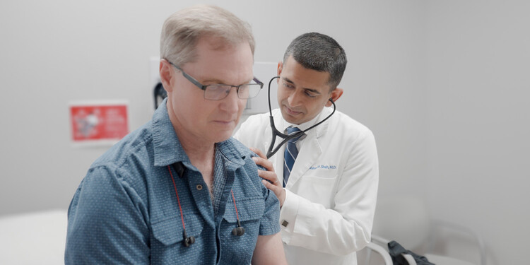 A doctor listens to a patient's heart