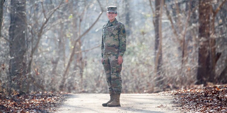 Madison Culler smiles on a trail wearing her military uniform near her home in Mebane, NC.