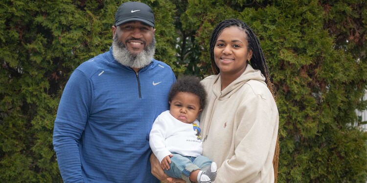 Tyrone and Tisha Hibbler hold their son, King, outside in Durham.