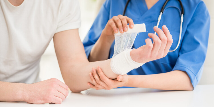 A physician wraps a patient's wrist