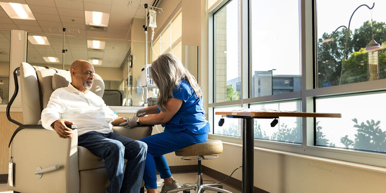 A nurse sets a patient up for an infusion