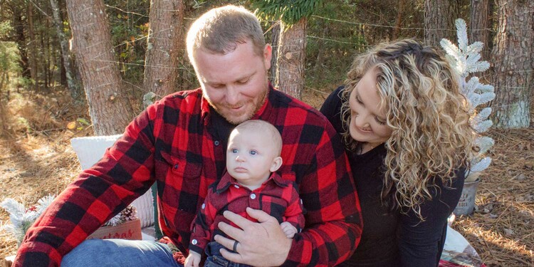 Man and wife look at baby boy