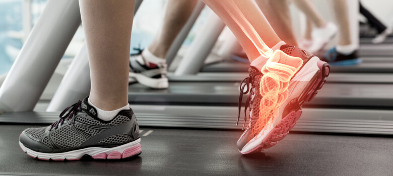 Woman walking on treadmill with ankle pain