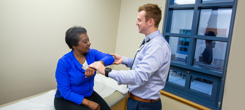 A provider looks at a patient's shoulder