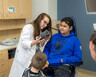 A doctor shows Brayden and his family a 3D-printed skull
